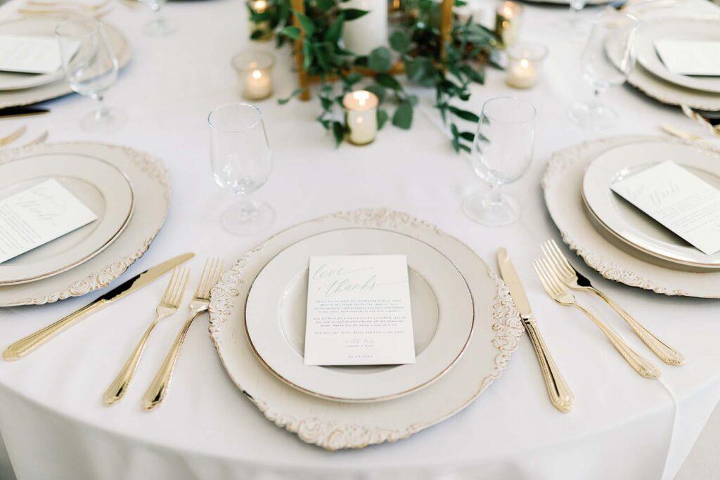A neutral table setting for a wedding at The Cinnamon Barn.